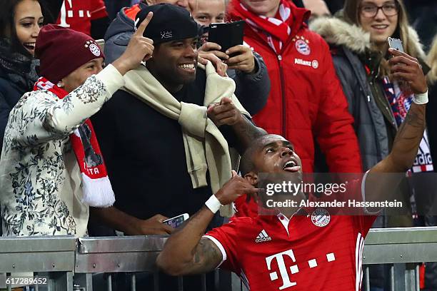 Douglas Costa of Bayern Muenchen celebrates with a selfie after he scores his team's 2nd goal during the Bundesliga match between Bayern Muenchen and...