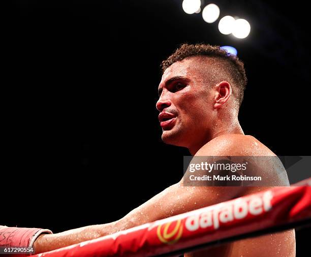 Anthony Ogogo Of England is pulled out by his trainer Tony Sims during the 8th round against Craig Cunningham Of England during their WBC...