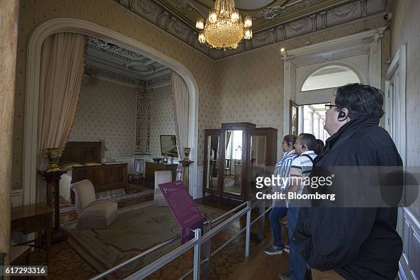 Visitors listen to an audio tour while viewing the room of Porfirio Diaz, former president of Mexico, inside the Chapultepec Castle, which houses...