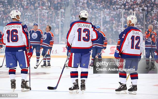 Laurie Boschman, Teemu Selanne and Doug Smail of the Winnipeg Jets alumni line up during the 2016 Tim Hortons NHL Heritage Classic alumni game at...