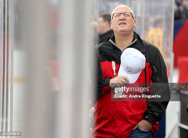 Bill Daly stands for the Canadian national anthem during the 2016 Tim Hortons NHL Heritage Classic alumni game at Investors Group Field on October...