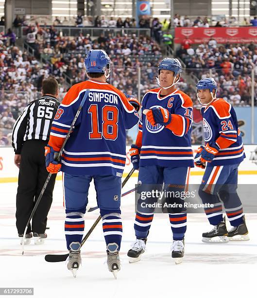 Mark Messier celebrates with Craig Simpson of the Edmonton Oilers alumni after scoring a goal on Winnipeg Jets alumni during the 2016 Tim Hortons NHL...