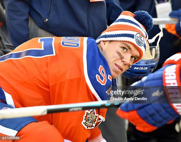 Connor McDavid of the Edmonton Oilers sits on the bench during warmup in advance of the 2016 Tim Hortons NHL Heritage Classic game at Investors Group...