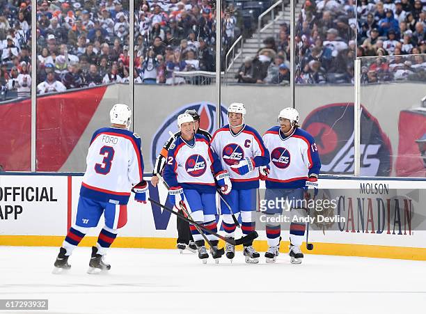 Winnipeg Jets alumni celebrate after a first period goal on Edmonton Oilers alumni during the 2016 Tim Hortons NHL Heritage Classic alumni game at...