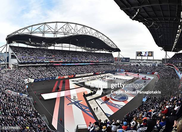 Fans stand for the Canadian national anthem during the 2016 Tim Hortons NHL Heritage Classic alumni game at Investors Group Field on October 22, 2016...