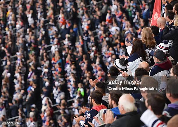 Fans cheer on the Winnipeg Jets and Edmonton Oilers alumni during the 2016 Tim Hortons NHL Heritage Classic alumni game at Investors Group Field on...