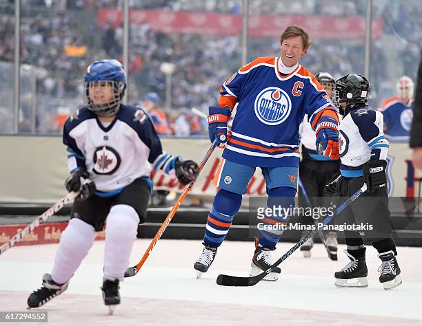 Wayne Gretzky of the Edmonton Oilers alumni plays with kids from the TimBits Hockey Program during the 2016 Tim Hortons NHL Heritage Classic alumni...
