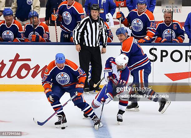 Jari Kurri of the Edmonton Oilers alumni battles for a loose puck with Kris King of the Winnipeg Jets alumni during the 2016 Tim Hortons NHL Heritage...