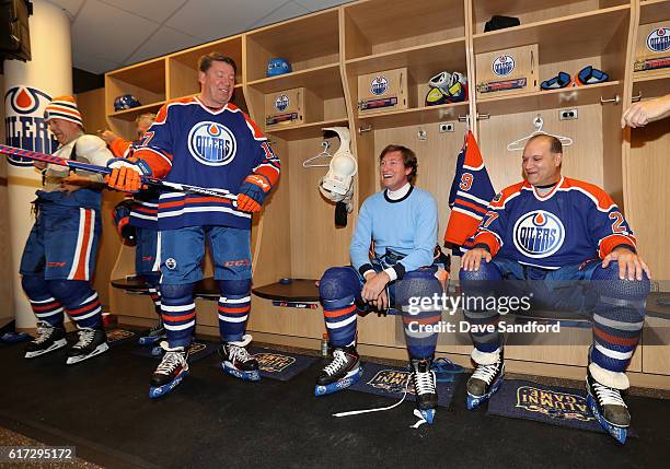 Jari Kurri , Wayne Gretzky and Dave Semenko of the Edmonton Oilers alumni share a laugh in the locker room before playing in the 2016 Tim Hortons NHL...