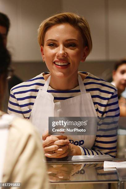 Actress Scarlett Johansson smiles at the opening of the Yummy Pop gourmet popcorn shop in the Marais district of Paris on October 22, 2016. The...