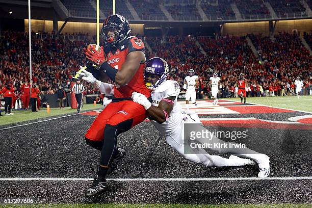 Dowdy of the Cincinnati Bearcats catches a pass for a touchdown while being defended by Terrell Richardson of the East Carolina Pirates during the...