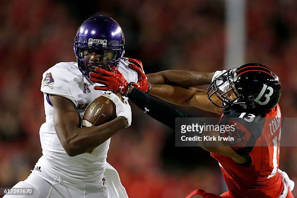 Zay Jones of the East Carolina Pirates stiff-arms Grant Coleman of the Cincinnati Bearcats while carrying the ball during the first quarter at...
