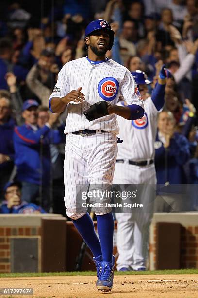 Dexter Fowler of the Chicago Cubs reacts after scoring a run on an RBI single hit by Kris Bryant in the first inning against the Los Angeles Dodgers...