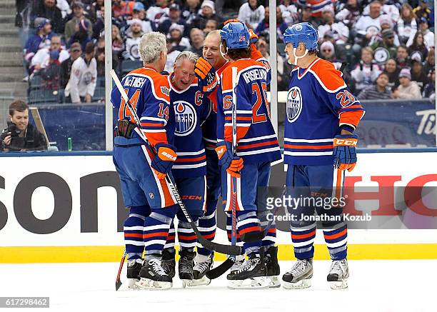 Craig MacTavish, B.J. MacDonald, Dave Semenko, Mike Krushelnyski and Craig Muni of the Edmonton Oilers alumni celebrate a third period goal against...