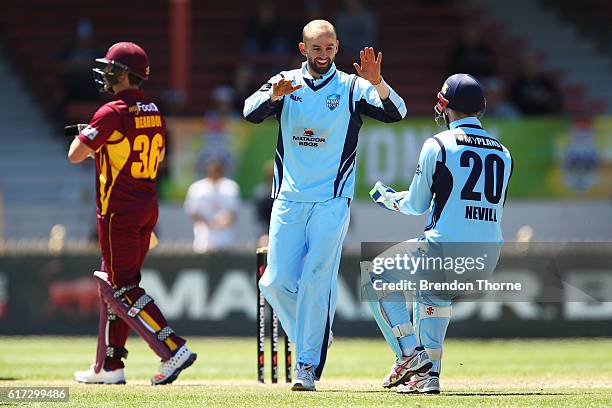 Nathan Lyon of the Blues celebrates with team mate Peter Nevill after claiming the wicket of Ben Cutting of the Bulls during the Matador BBQs One Day...