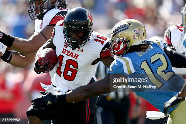 Cory Butler-Byrd of the Utah Utes breaks a tackle by Jayon Brown of the UCLA Bruins during the first half of a game at the Rose Bowl on October 22,...
