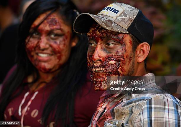 October 22: Zombies Diana Lopez, left, and Jeffery Rosales, bloodied and looking for humans to eat on the 16th St. Mall during the 11th annual Zombie...