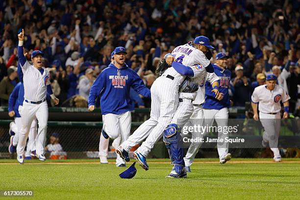 Aroldis Chapman celebrates with Willson Contreras of the Chicago Cubs after defeating the Los Angeles Dodgers 5-0 in game six of the National League...