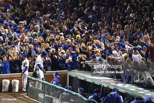 Anthony Rizzo of the Chicago Cubs celebrates with manager Joe Maddon at the dugout after hitting a solo home run in the fifth inning against the Los...