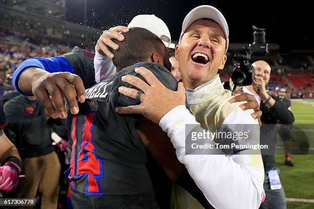 Head coach Chad Morris of the Southern Methodist Mustangs celebrates with Jackson Mitchell of the Southern Methodist Mustangs after the Southern...