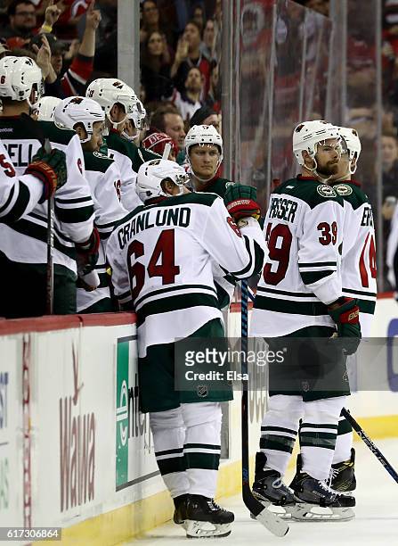Nate Prosser of the Minnesota Wild and the rest of his teammates react after the overtime loss to the New Jersey Devils on October 22, 2016 at...