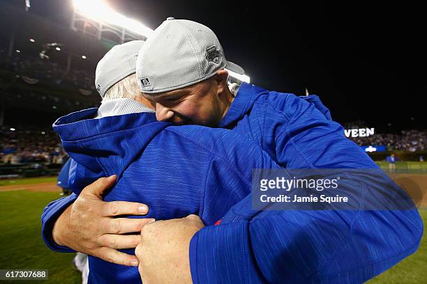 Jon Lester of the Chicago Cubs celebrates with manager Joe Maddon after defeating the Los Angeles Dodgers 5-0 in game six of the National League...