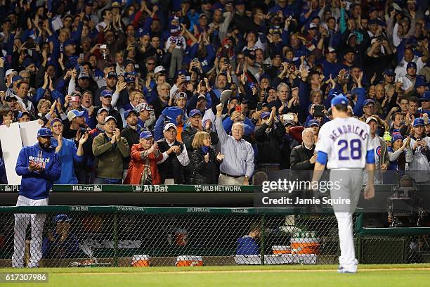 Chicago Cubs fans cheer as Kyle Hendricks of the Chicago Cubs is relieved in the eighth inning during game six of the National League Championship...