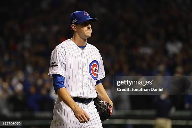 Kyle Hendricks of the Chicago Cubs walks back to the dugout after being relieved in the eighth inning during game six of the National League...