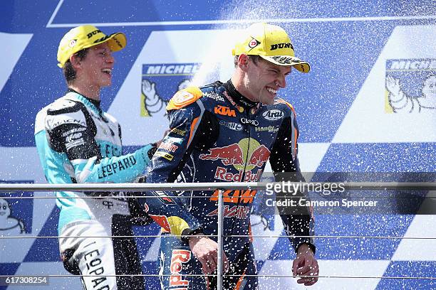 Brad Binder of South Africa and Red Bull KTM Ajo is sprayed with champagne by Andrea Locatelli of Italy and Leopard Racing following the Moto3 race...