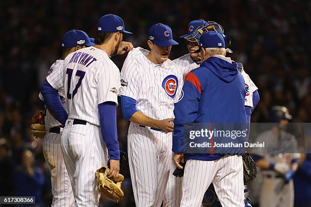 Kyle Hendricks of the Chicago Cubs is relieved in the eighth inning by manager Joe Maddon during game six of the National League Championship Series...