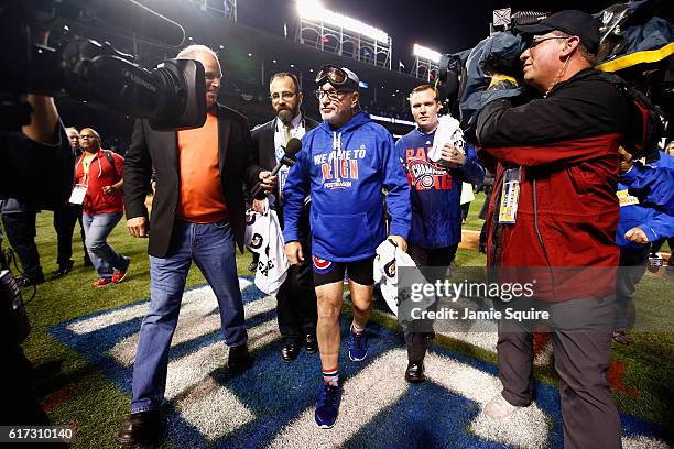 Manager Joe Maddon of the Chicago Cubs walks off the field after defeating the Los Angeles Dodgers 5-0 in game six of the National League...