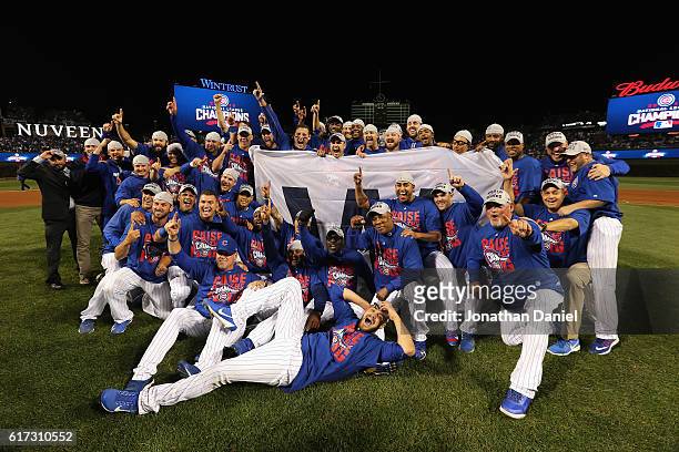 The Chicago Cubs pose after defeating the Los Angeles Dodgers 5-0 in game six of the National League Championship Series to advance to the World...