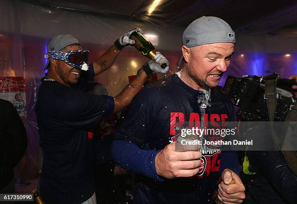 Hector Rondon and Jon Lester of the Chicago Cubs celebrate in the clubhouse after defeating the Los Angeles Dodgers 5-0 in game six of the National...