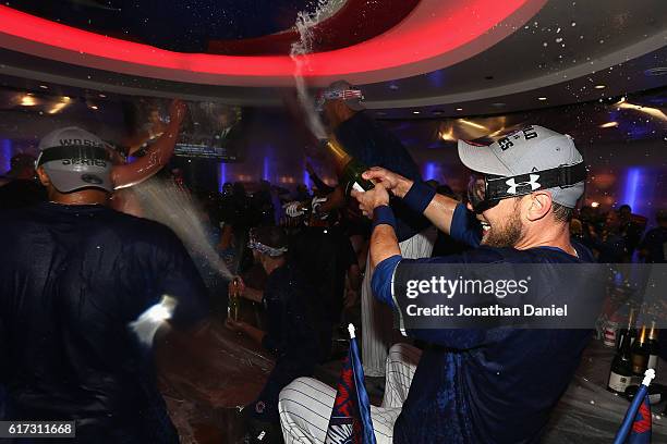 Ben Zobrist of the Chicago Cubs celebrates in the clubhouse after defeating the Los Angeles Dodgers 5-0 in game six of the National League...