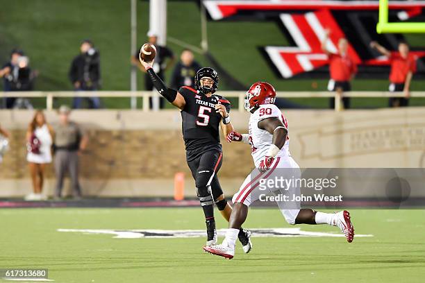 Patrick Mahomes II of the Texas Tech Red Raiders passes the ball under pressure from Neville Gallimore of the Oklahoma Sooners during the game on...