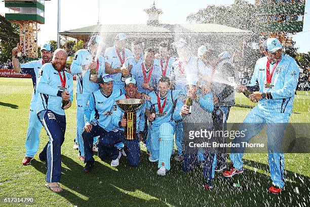 Blues players celebrates with the Matador BBQs One Day Cup after victory in the Matador BBQs One Day Cup Final match between Queensland and New South...