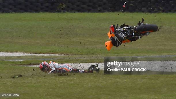 Repsol Honda Team's Spanish rider Marc Marquez crashes during the MotoGP race at the Australian Grand Prix at Phillip Island on October 23, 2016. /...