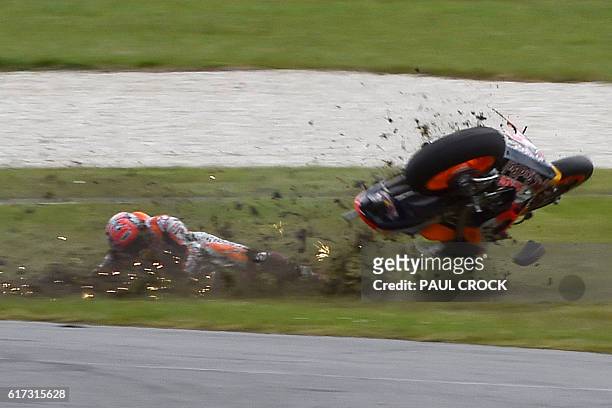 Repsol Honda Team's Spanish rider Marc Marquez crashes during the MotoGP race at the Australian Grand Prix at Phillip Island on October 23, 2016. /...