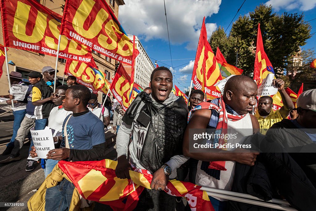 Thousands of people shout slogans and wave flags as they...