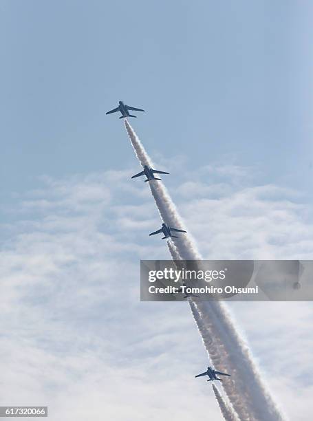Aircrafts from Japan's Air Self-Defense Force's acrobatic flight team, known as Blue Impulse, fly during the annual review at the Japan Ground...