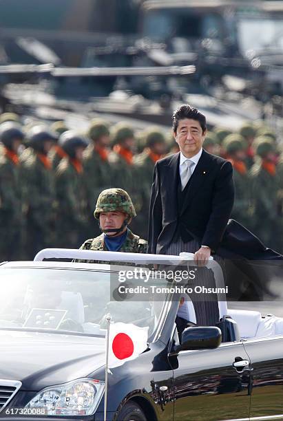 Japanese Prime Minister Shinzo Abe, center right, inspects troops of the Self Defense Forces during the annual review at the Japan Ground...