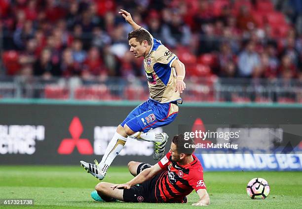 Wayne Brown of the Jets is challenged by Robbie Cornthwaite of the Wanderers during the round three A-League match between the Western Sydney...