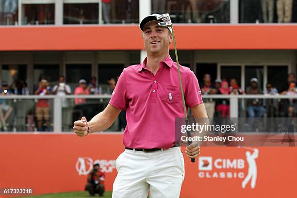 Justin Thomas of the United States celebrates on the 18th hole during day four of the 2016 CIMB Classic at TPC Kuala Lumpur on October 23, 2016 in...