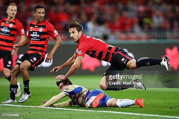 Aritz Borda of the Wanderers falls over the top of Devante Clut of the Jets during the round three A-League match between the Western Sydney...