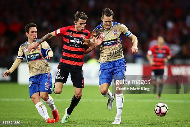 Nigel Boogaard of the Jets is challenged by Scott Neville of the Wanderers during the round three A-League match between the Western Sydney Wanderers...