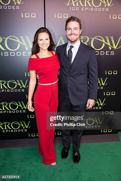 Actors Cassandra Jean and Stephen Amell arrive on the green carpet for the Celebration of the 100th Episode of CW's "Arrow" at the Fairmont Pacific...