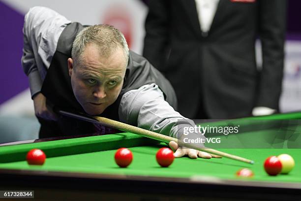 John Higgins of Scotland plays a shot during the first round match against Sydney Wilson of England on Day 1 of the International Championship 2016...