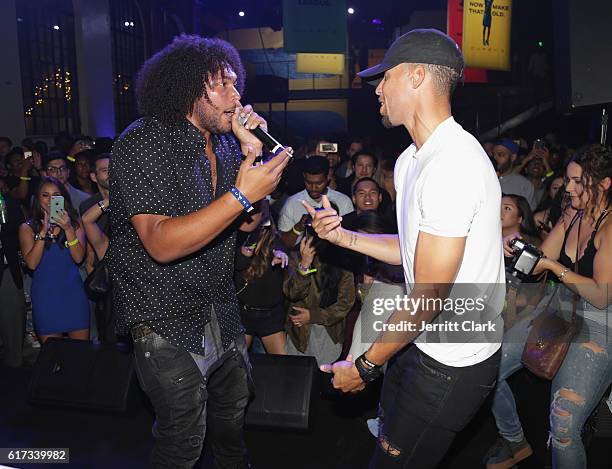 Stephen Curry joins his cousin, rapper Devontee onstage for a performance during the Under Armour Curry 3 Launch at Skylight Powerhouse on October...