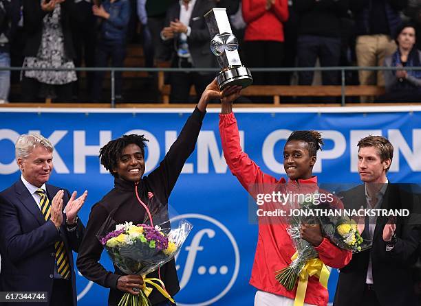 Sweden's Elias Ymer and Mikael Ymer pose with the trophy during an award ceremony after defeating Croatia's Mate Pavic and New Zealand's Michael...