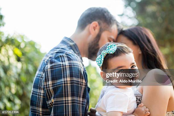 happy baby daughter in her parents' arms - mexican mothers day 個照片及圖片檔